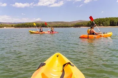 a group of people kayaking on a lake at Camping-Bungalows Altomira in Navajas