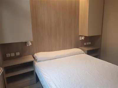 a living room with a couch and two chairs at Camping-Bungalows Altomira in Navajas