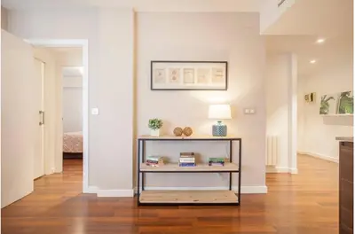 a living room with a table with a lamp at Hi Valencia Apartments - Jorge Juan in Valencia