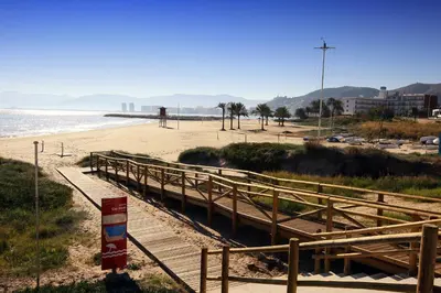 a wooden boardwalk leading down to a beach at Hotel Carabela 2 in Cullera