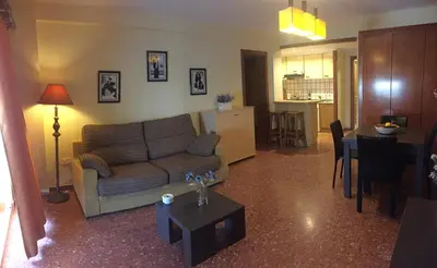 a living room with a couch and a table at Florazar de Ensueño in Cullera