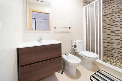 a bathroom with a sink and a toilet and a shower at Hostal Mitre Paterna in Paterna