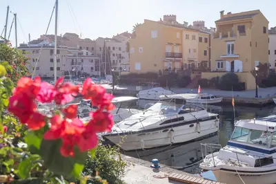 a group of boats docked in a marina with buildings at Travel Habitat Casa con embarcadero. in Port Saplaya