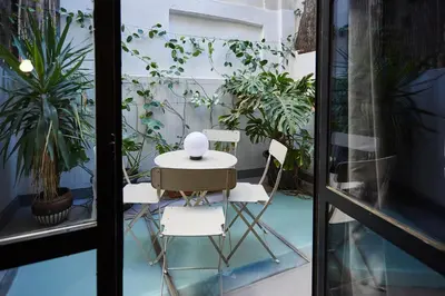 a table and chairs on a balcony with plants at Bubusuites in Valencia