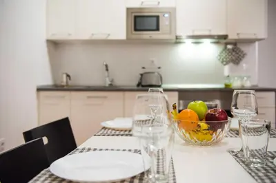 a table with a bowl of fruit and wine glasses at Ambrosio Flats Valencia - El Carmen in Valencia