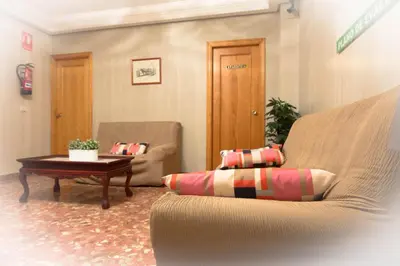 a living room with a couch and a table at L'Oncle Pere Habitacions in L'Alcúdia