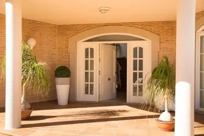 an entrance to a house with plants in pots at MD Villa Cullera Cap Blanc in Faro de Cullera
