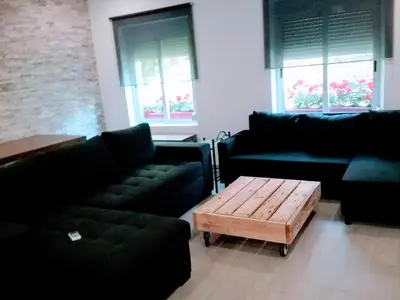 a living room with black couches and a coffee table at New Trendy apartment in Valencia