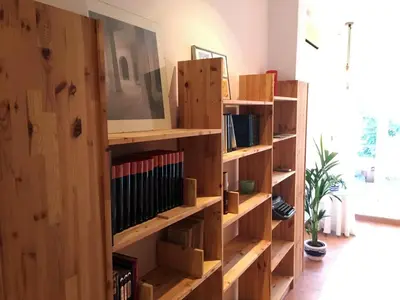 a book shelf filled with books in a room at Casa Cabanyal in Valencia