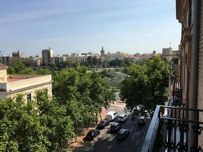 a view of a city street with cars parked at Travel Habitat Jardines Rio Turia. in Valencia