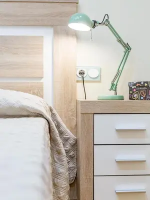 a bedroom with a bed and a desk with a lamp at Travel Habitat Jardines Rio Turia. in Valencia