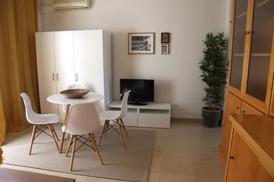 a living room with a table and chairs and a tv at El Globo in Valencia