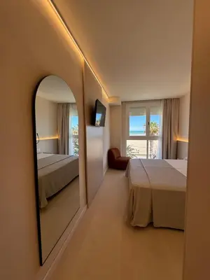 a bedroom with two beds and a large mirror at El Globo in Valencia
