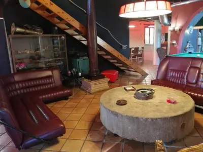 a room with a table and chairs and a pool table at Ca Carmela casa con Encanto con Piscina 