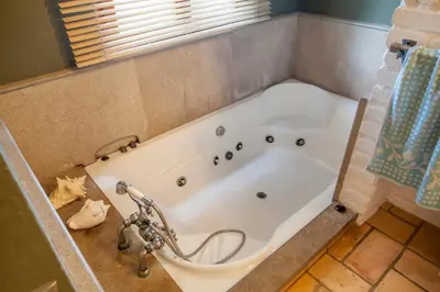 a bath tub in a bathroom with a shower at Ca Carmela casa con Encanto con Piscina 