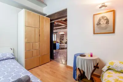 a bedroom with a bed and a table in a room at Ca Carmela casa con Encanto con Piscina 
