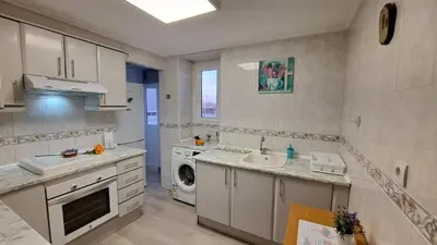 a kitchen with a sink and a washing machine at Casa de Maria in Valencia