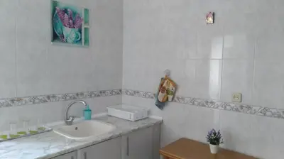 a white bathroom with a sink and a mirror at Casa de Maria in Valencia