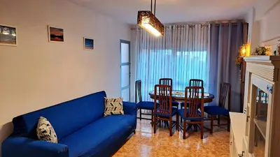 a living room with a blue couch and a table at Casa de Maria in Valencia