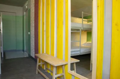 a room with a bench and a bunk bed at room00 Valencia Hostel in Valencia
