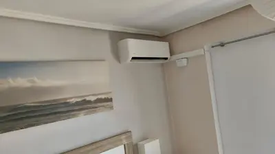 a room with a wall with a painting of the ocean at Apartamento Playa el Cabanyal in Valencia