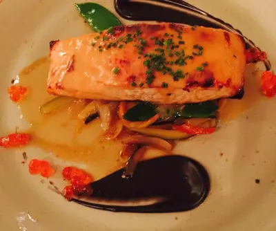 a white plate with a piece of food on a spoon at Hotel Playa Canet in Canet de Berenguer
