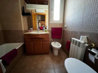 a bathroom with a sink and a toilet and a mirror at La perla de oasis in Lliria