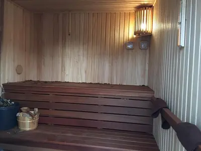a wooden bench in the corner of a room at La perla de oasis in Lliria
