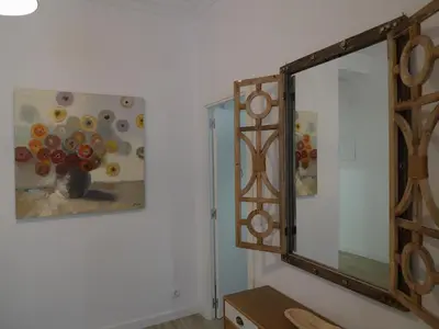 a mirror in a room with a painting on the wall at TTdSSa VLC Purísima Street in Valencia