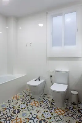 a white bathroom with a toilet and a window at TTdSSa VLC Purísima Street in Valencia