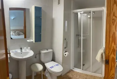 a bathroom with a shower and a toilet and a sink at Hotel Valldigna in Tavernes de Valldigna
