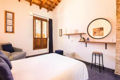 a bedroom with a white bed and a mirror at Casa Sibarita in Rafelguaraf
