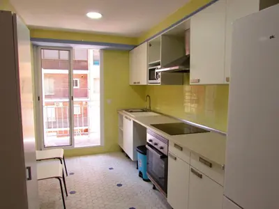 a kitchen with white cabinets and a sink and a window at Cullera Beach by Zagal Apartments in Cullera