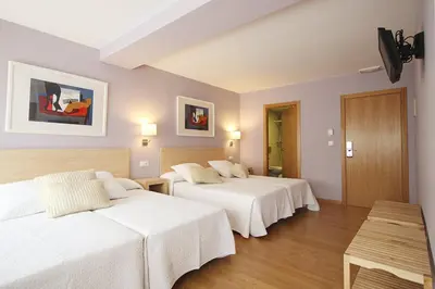 a hotel room with two beds with white sheets at Dormavalencia Hostel in Valencia