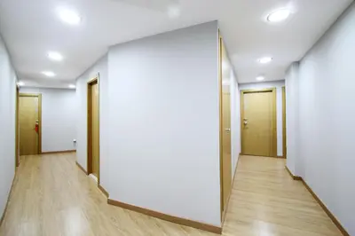 an empty corridor of an office building with a large mirror at Dormavalencia Hostel in Valencia