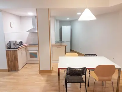 a kitchen and dining room with a table and chairs at Dormavalencia Hostel in Valencia