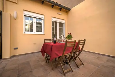 a dining room table with a red table cloth and chairs at Beds & Breaks Verdi 2 in Valencia
