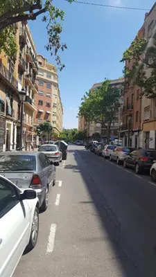 a street with cars parked on the side of the road at Domus Valencia Apartamentos Loft zona Pechina in Valencia