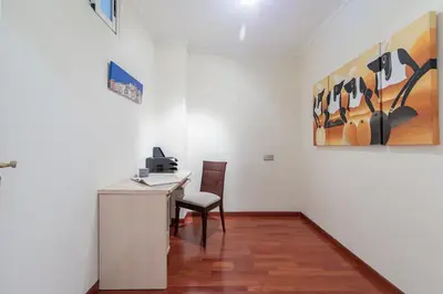 an office with a desk and a chair and a painting at Ruzafa Luis Santangel in Valencia