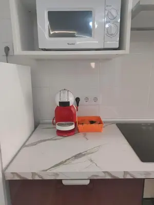 a red tea pot sitting on top of a kitchen counter at Altura in Valencia