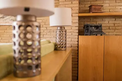 a lamp on a table next to a couch at MD Sueca in Valencia