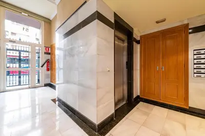 a hallway with a door in a building at MD Abastos in Valencia