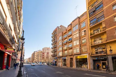 a city street with tall buildings and a street light at MD Abastos in Valencia