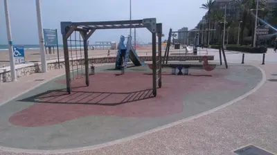 a playground at the beach with a swing at Apartamento a 10 metros del mar in Cullera