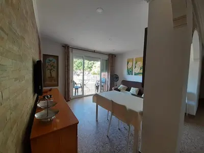 a living room with a table and a couch at Apartamento a 10 metros del mar in Cullera