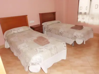 a room with two beds and a mirror at Hostal Abastos in Valencia