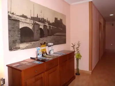 a room with a picture of a bridge on the wall at Hostal Abastos in Valencia