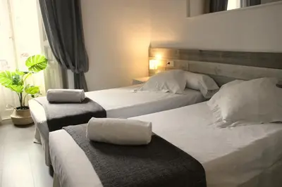 a hotel room with two beds and a window at The Art Boutique Colon in Valencia