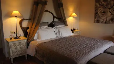 a bedroom with a bed with two night stands and two lamps at La Mozaira in Alboraya