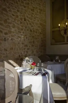 a dining room with a table with a white table cloth at La Mozaira in Alboraya